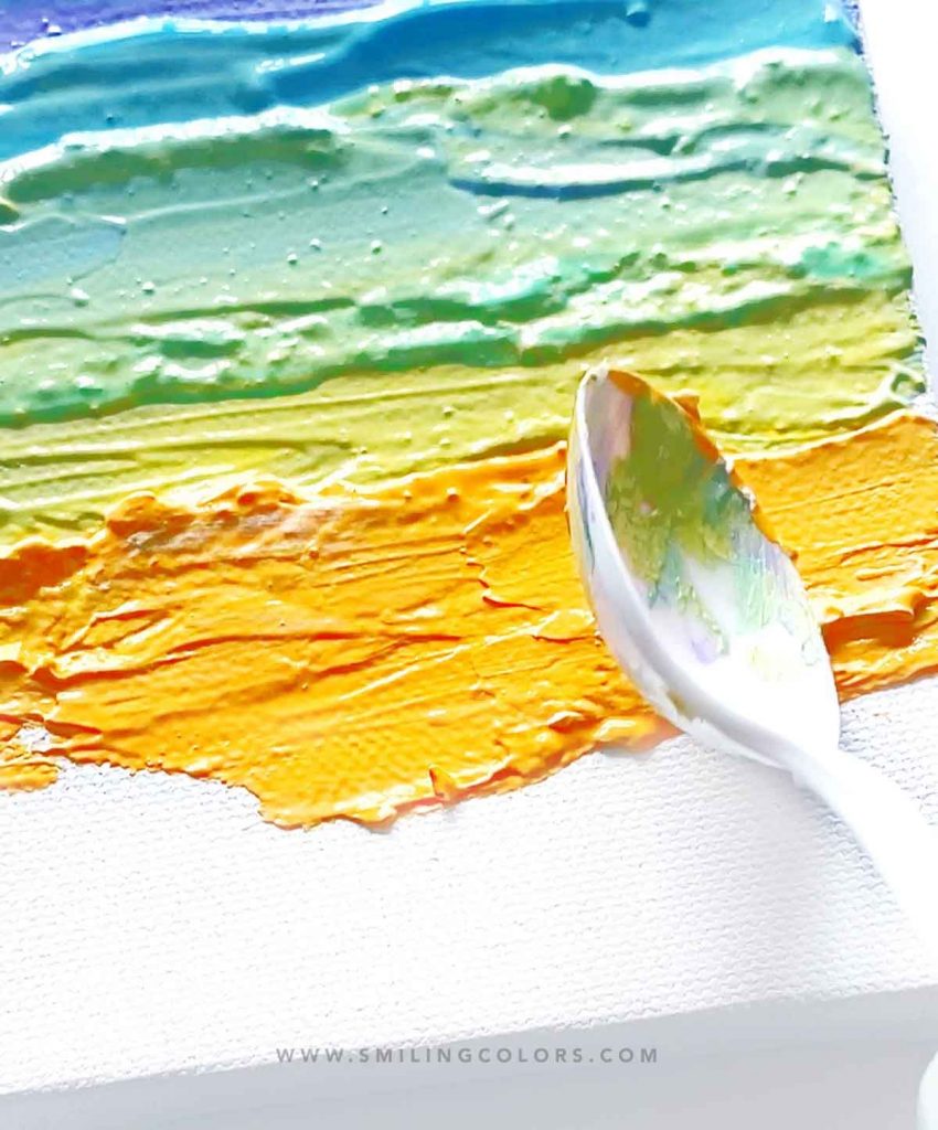 painting with a spoon using texture medium