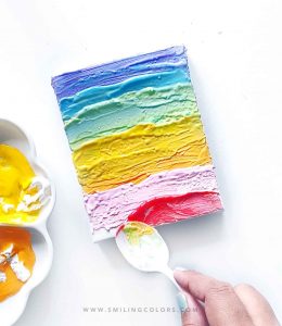 rainbow canvas painting with a spoon