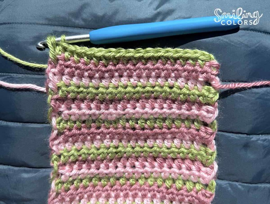 Carrying yarn colors up with no yarn cutting